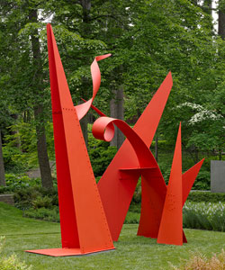 A bright red large sculpture is located in the sculpture garden.